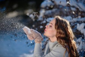 girl playing with snow